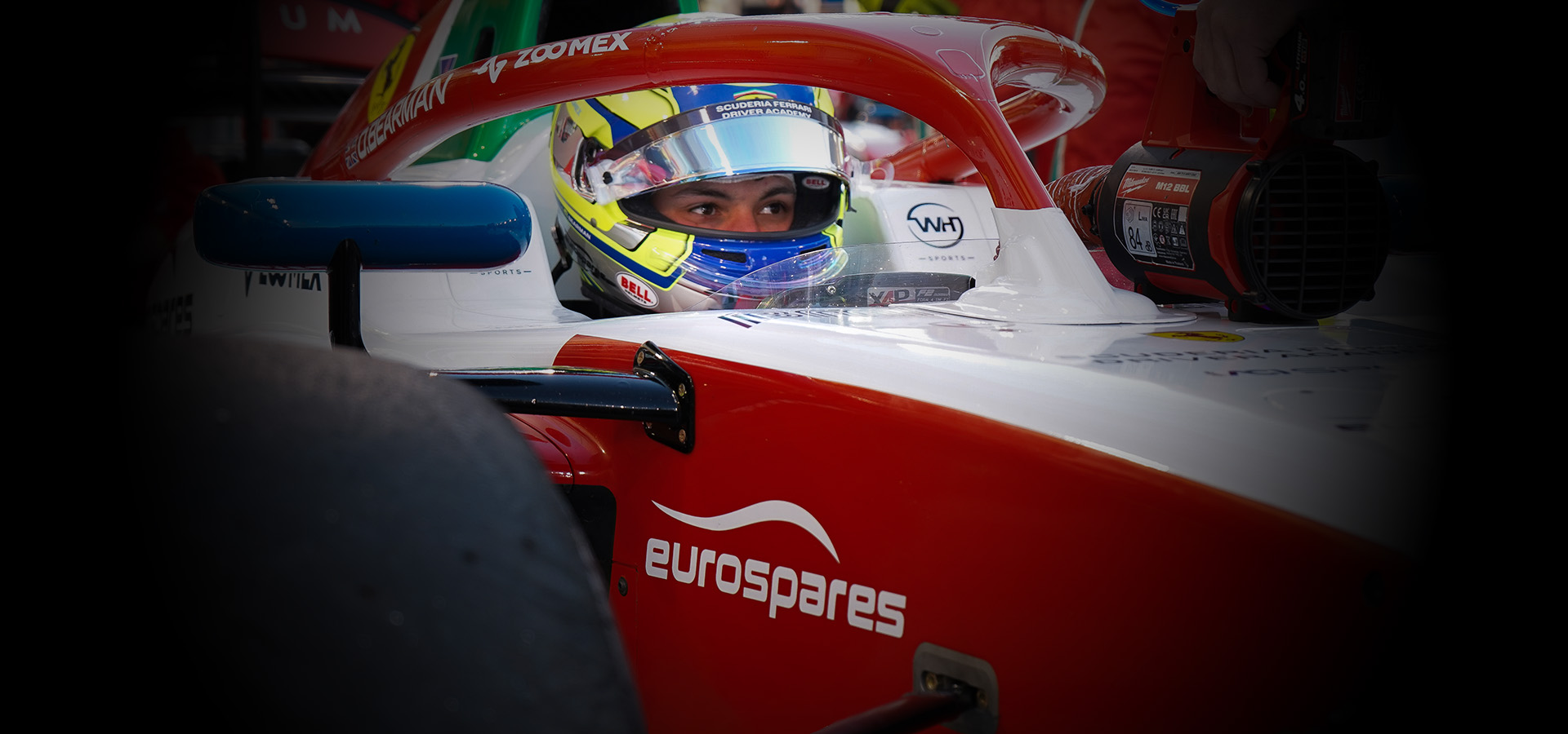 Oliver Bearman sitting in his Formula 2 racing car which has Eurospares logo on the side. 