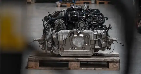 Close-up of an immaculate Porsche 992 GT3 engine with visible engine internals.